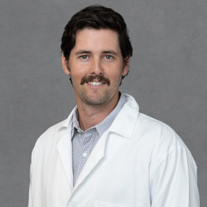 Jonathan Rutt, primary care provider at Optima Medical in Queen Creek, Arizona, wearing a white medical coat.