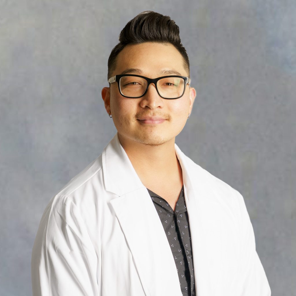 Dae Woong Kim, medical provider at Optima Medical in Queen Creek, Arizona, wearing glasses and a white coat.