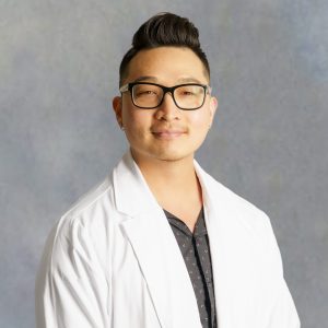 Dae Woong Kim, medical provider at Optima Medical in Queen Creek, Arizona, wearing glasses and a white coat.