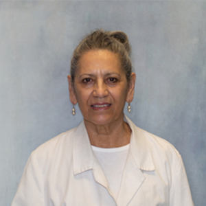 Celia Elias, medical provider at Optima Medical in Tucson, Arizona, in a white coat with a neutral background.
