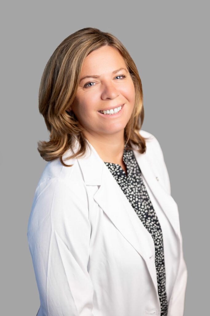Carolyn Kathan, experienced healthcare provider at Optima Medical in Prescott Valley, Arizona, wearing a white coat in professional photo.